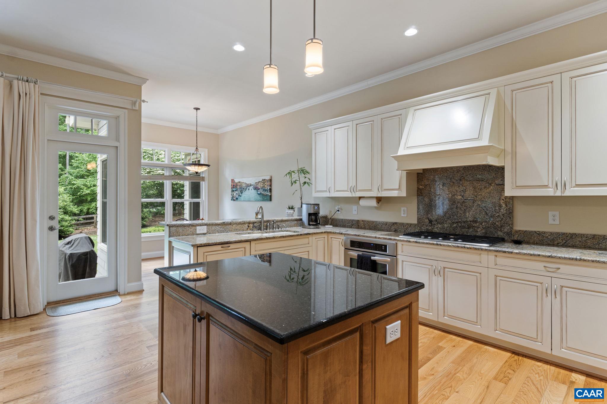 2025 Farringdon Road Keswick, VA 22947 - Photo 13 of 55 a kitchen with granite countertop a stove a sink dishwasher and white cabinets with wooden floor