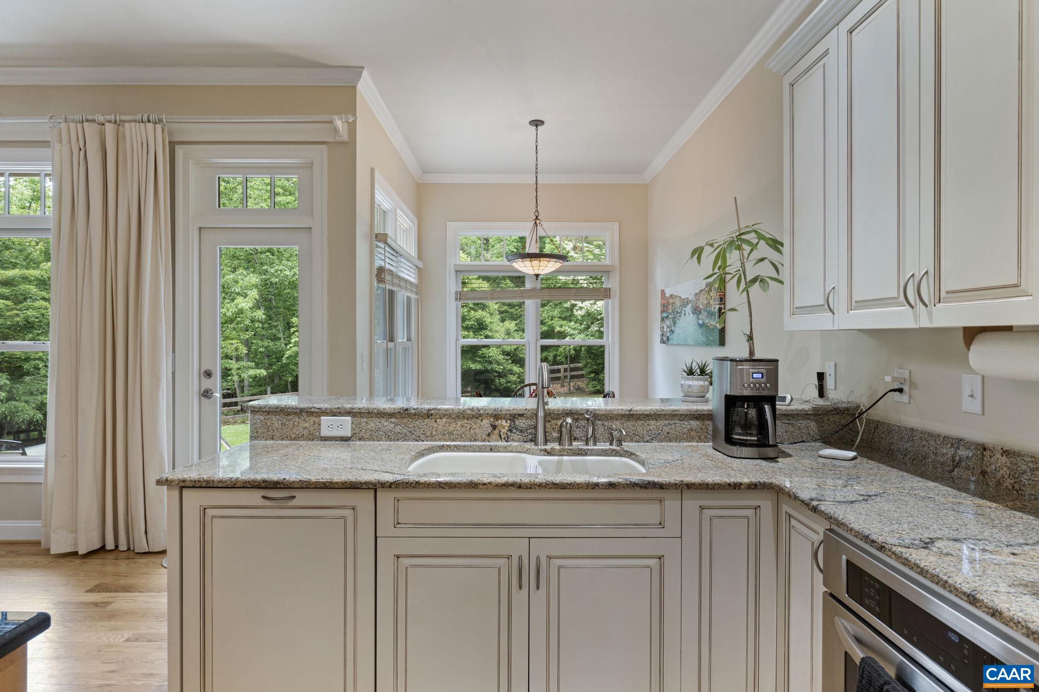 2025 Farringdon Road Keswick, VA 22947 - Photo 15 of 55 a kitchen with stainless steel appliances granite countertop a sink a counter and a window