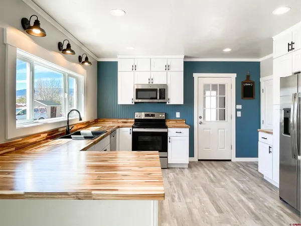 a kitchen with a sink and a stove top oven