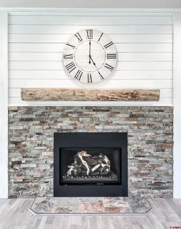 a fireplace with a clock on wall