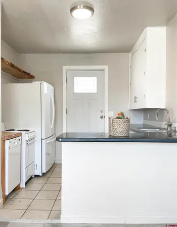 a white refrigerator freezer sitting inside of a kitchen