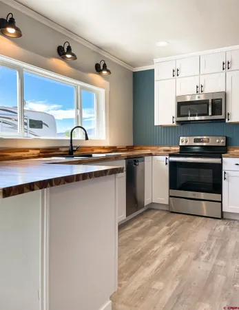 a kitchen with stainless steel appliances a sink and a stove
