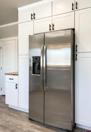 a kitchen with a refrigerator and cabinets