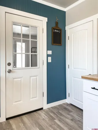 a view of a livingroom with wooden floor and cabinet