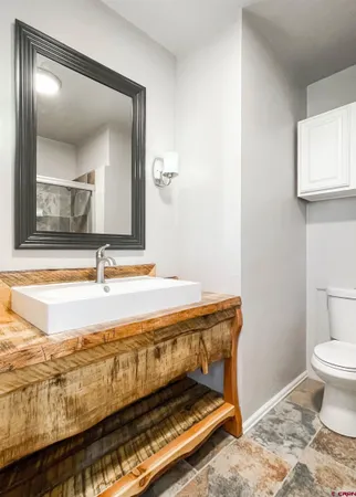 a bathroom with a sink mirror vanity and toilet