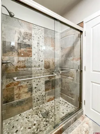 a bathroom with a glass shower door