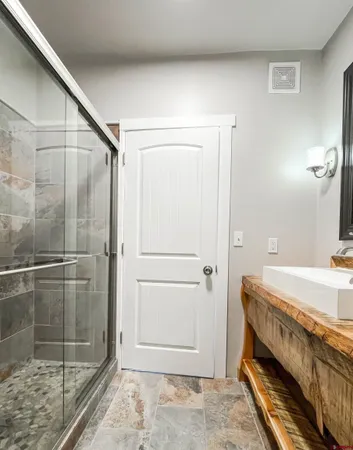 a bathroom with a shower and a sink
