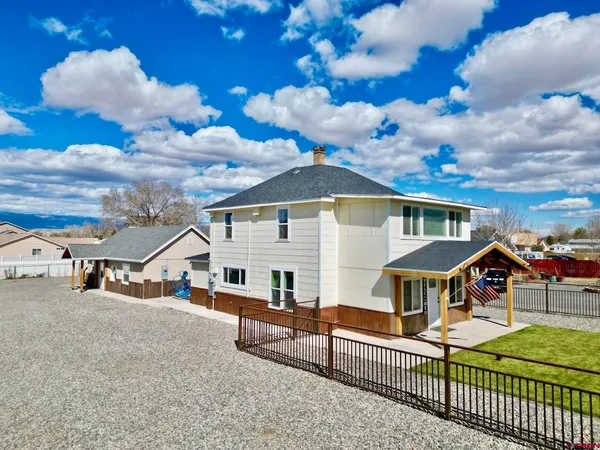 a view of a house with wooden fence