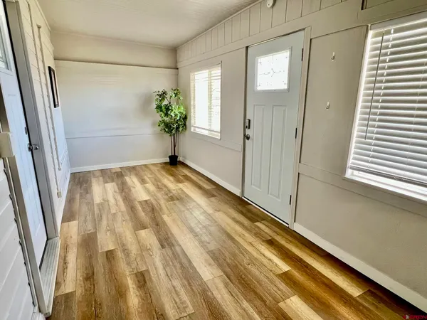 a view of a room with wooden floor and stairs