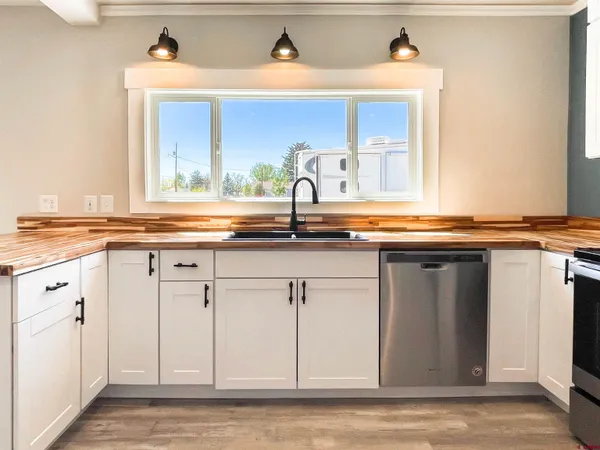 a kitchen with granite countertop a sink and cabinets