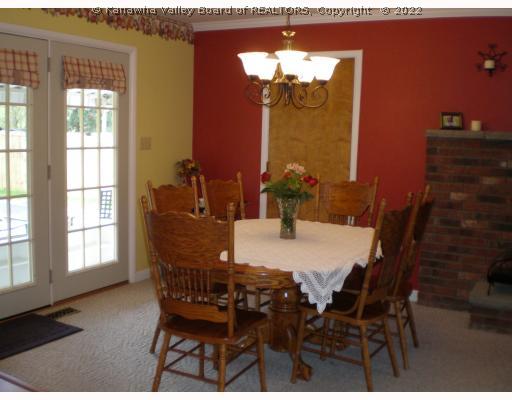 2533 Poca River Road South Poca, WV 25159 - Photo 8 of 8 Dining Room. This dining area adjoins the family room, the fireplace is visible to the right in this photo. The inground pool is fully visible from this room and the french doors open to a covered patio, poolside.