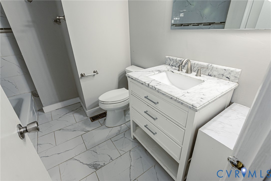 709 Deter Road Richmond, VA 23225 - Photo 26 of 38 Bathroom featuring white vanity with integrated si