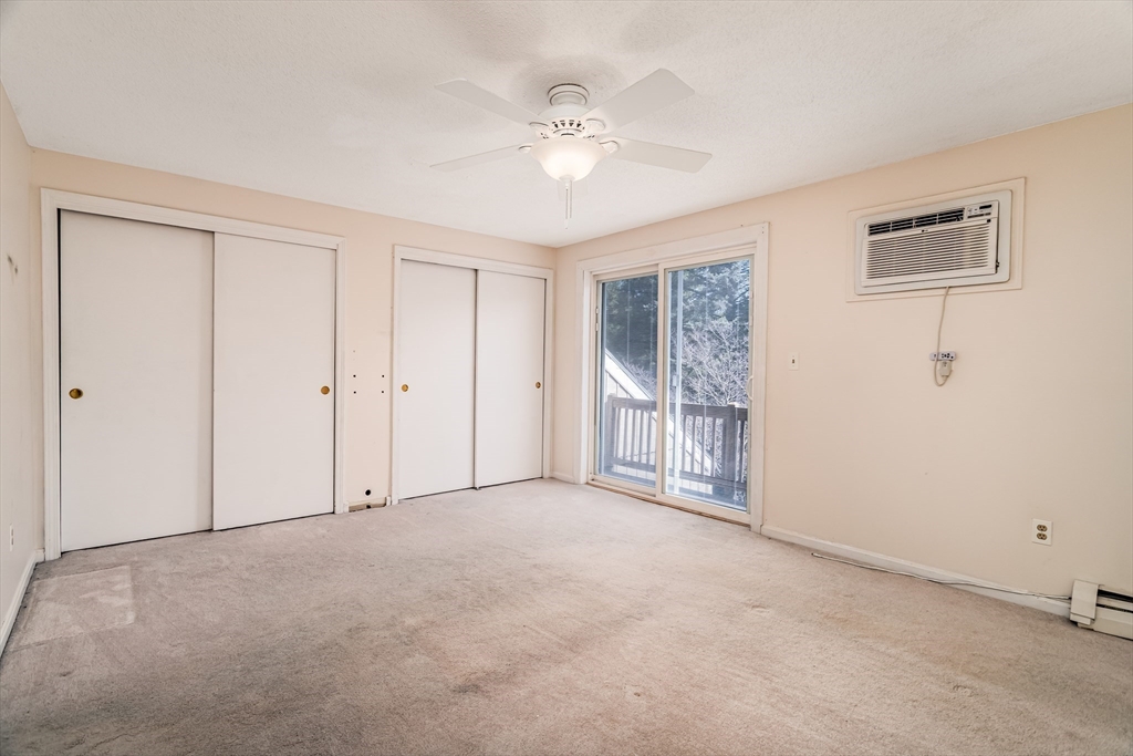 164 Ayer Road, Unit F4 Shirley, MA 01464 - Photo 12 of 34 a view of an empty room with a ceiling fan