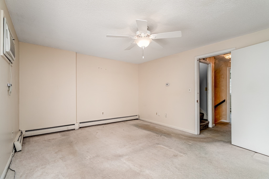 164 Ayer Road, Unit F4 Shirley, MA 01464 - Photo 14 of 34 an empty room with closet and a chandelier fan