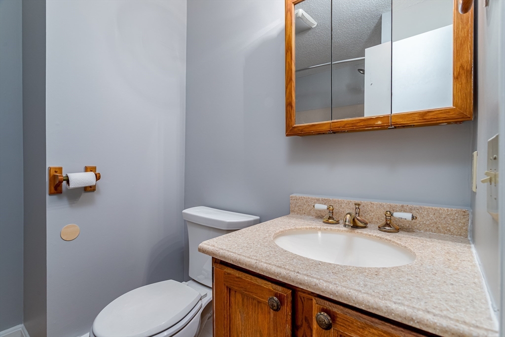 164 Ayer Road, Unit F4 Shirley, MA 01464 - Photo 17 of 34 a bathroom with a sink a toilet and mirror
