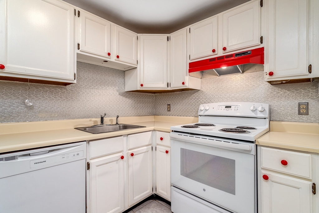 164 Ayer Road, Unit F4 Shirley, MA 01464 - Photo 4 of 34 a kitchen with white cabinets and white appliances