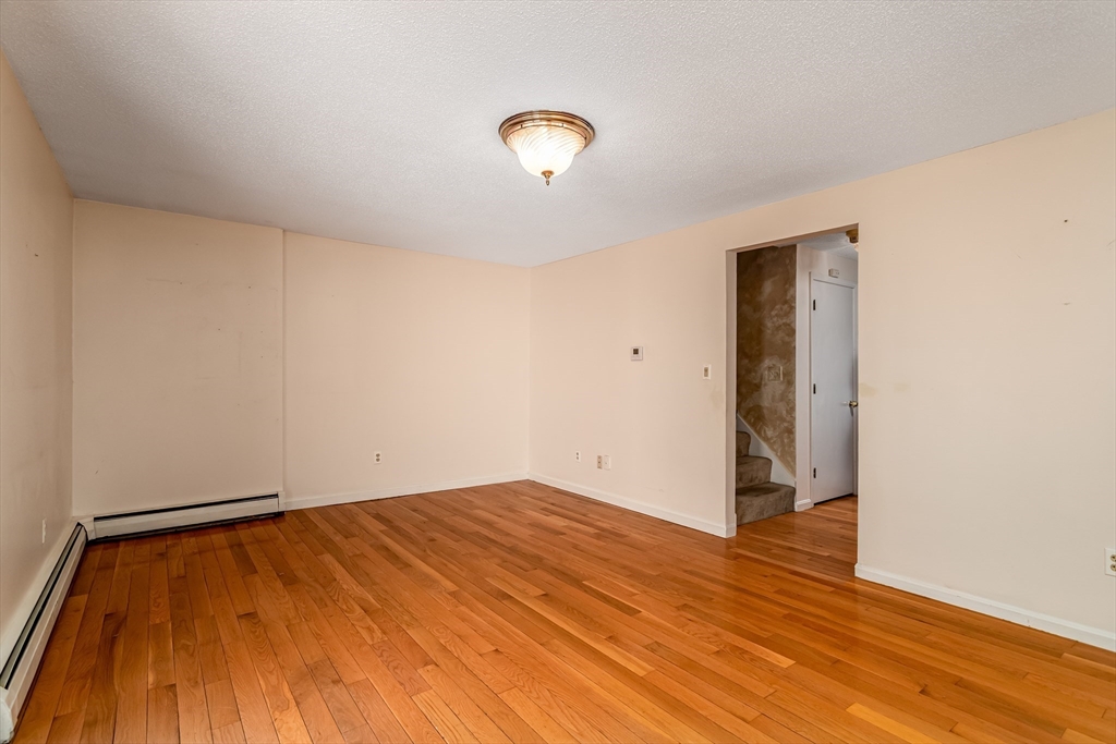 164 Ayer Road, Unit F4 Shirley, MA 01464 - Photo 10 of 34 a view of an empty room and wooden floor