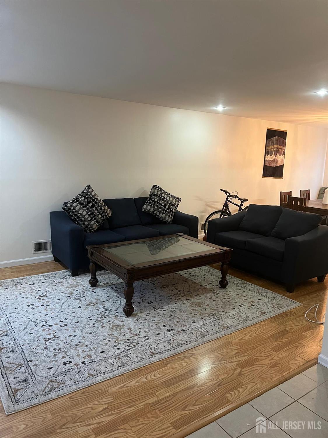 404 Maplecrest Road Edison, NJ 08820 - Photo 2 of 8 a living room with furniture a rug and a wooden floor