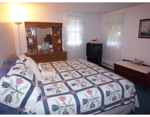 267 Ridge Street Arlington, MA 02474 - Photo 11 of 18 a bedroom with a bed and a mirror