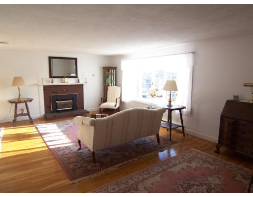 267 Ridge Street Arlington, MA 02474 - Photo 3 of 18 a living room with furniture a flat screen tv and a fireplace