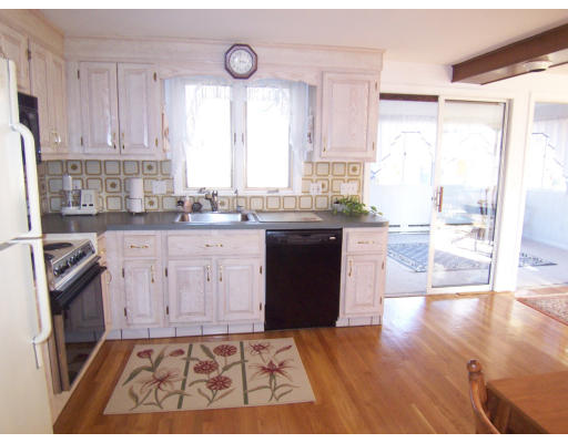 267 Ridge Street Arlington, MA 02474 - Photo 8 of 18 a kitchen with a sink a stove a refrigerator and cabinets