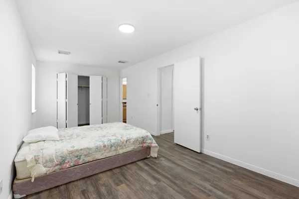 a bedroom with a bed and a closet