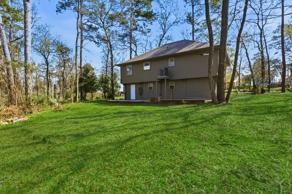 a front view of house with yard and trees