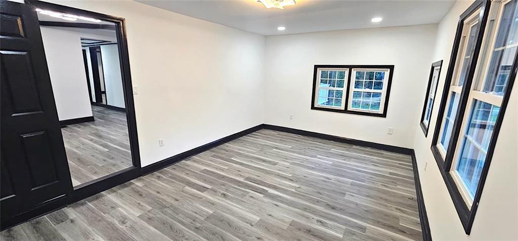 2895 Turner Church Road McDonough, GA 30252 - Photo 13 of 25 a view of an empty room with wooden floor and a window
