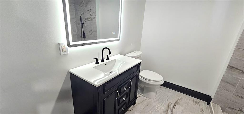 2895 Turner Church Road McDonough, GA 30252 - Photo 19 of 25 a bathroom with a sink a toilet and mirror