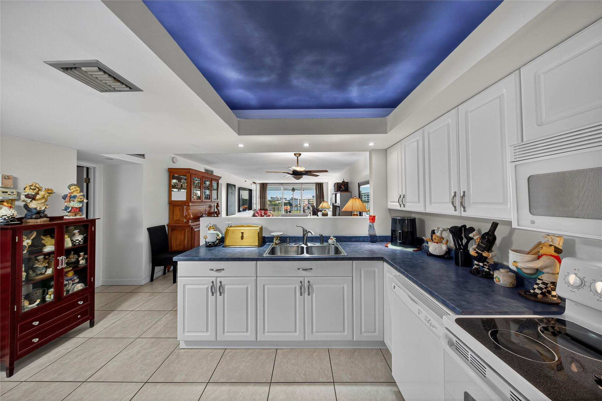 2900 North Course Drive, Unit 607 Pompano Beach, FL 33069 - Photo 12 of 48 a kitchen with a sink and cabinets