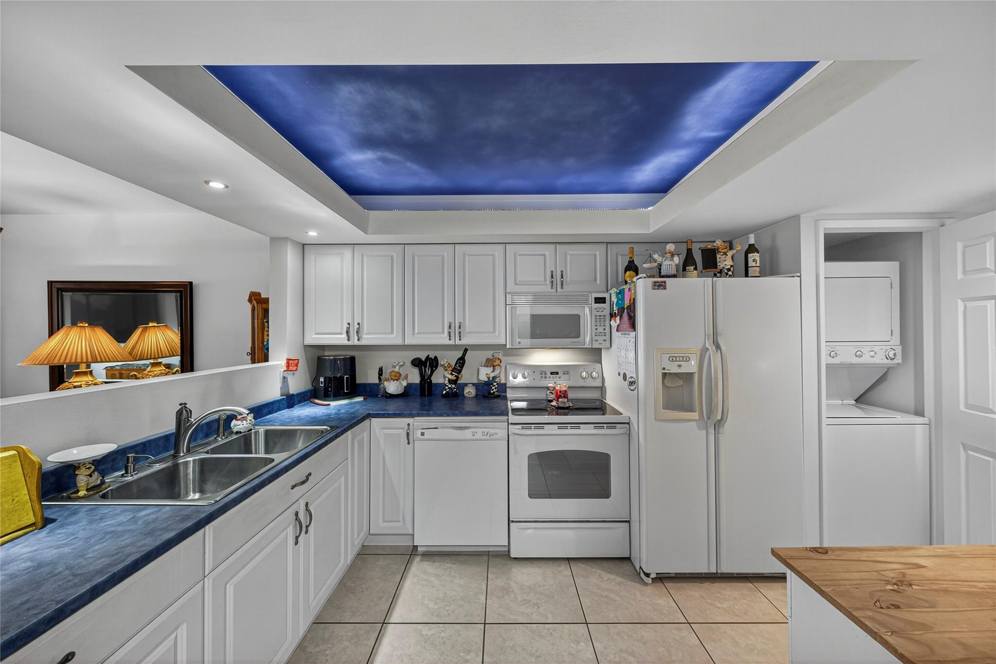 2900 North Course Drive, Unit 607 Pompano Beach, FL 33069 - Photo 14 of 48 a kitchen with a sink a refrigerator and cabinets