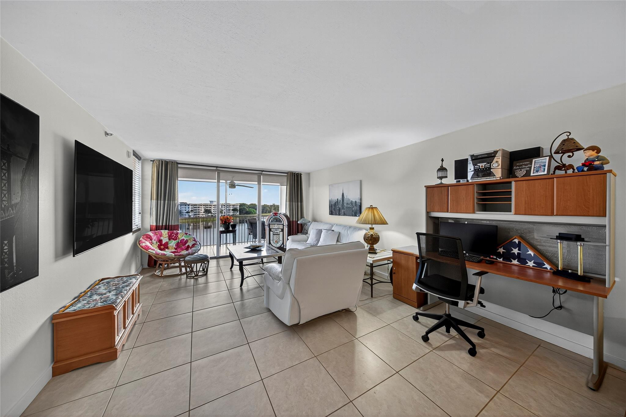 2900 North Course Drive, Unit 607 Pompano Beach, FL 33069 - Photo 24 of 48 a living room with furniture and a flat screen tv