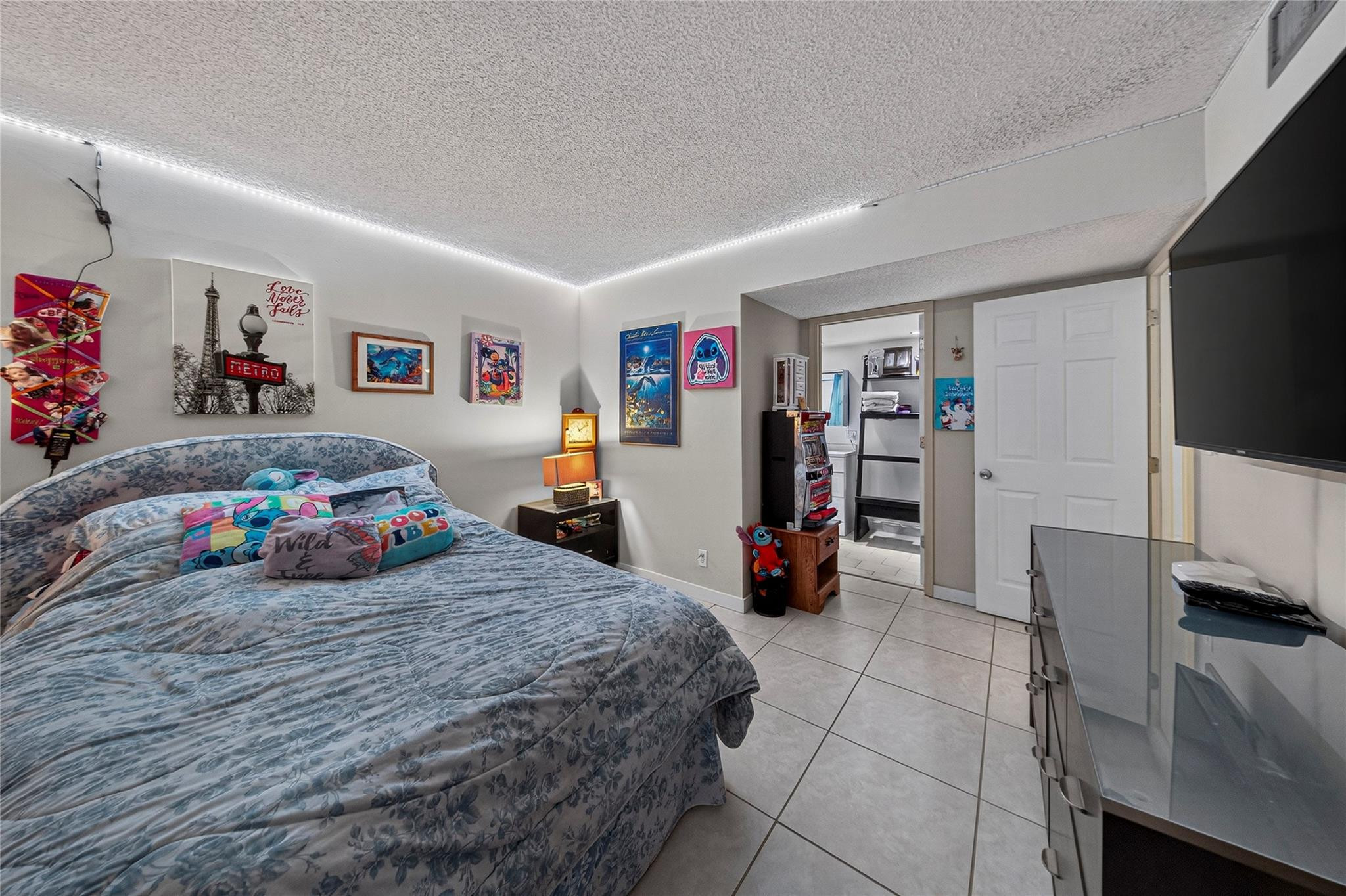 2900 North Course Drive, Unit 607 Pompano Beach, FL 33069 - Photo 38 of 48 a bedroom with a bed and a flat screen tv