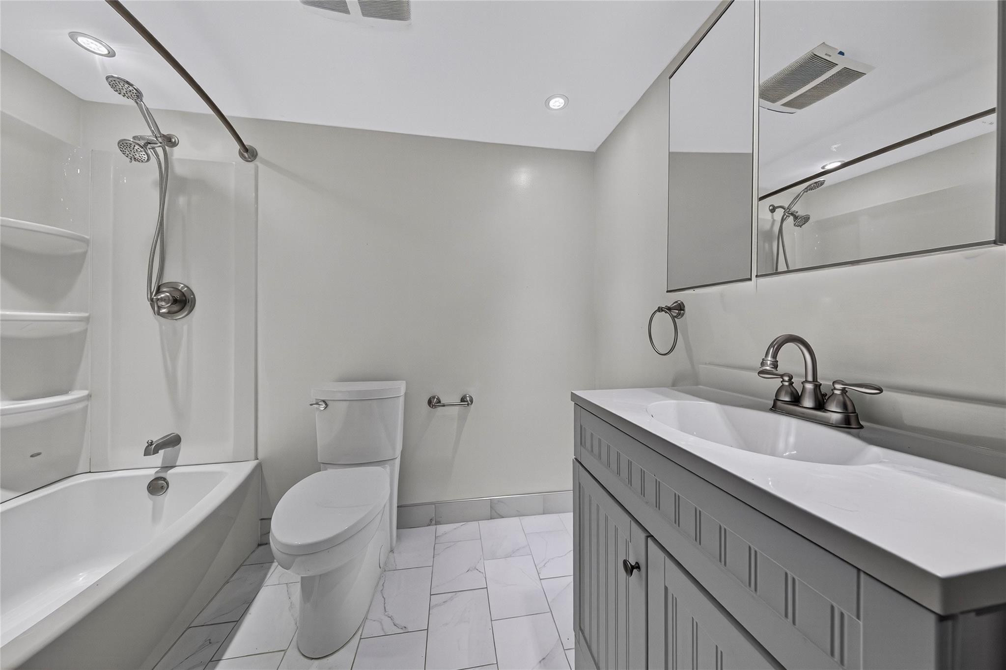 2900 North Course Drive, Unit 607 Pompano Beach, FL 33069 - Photo 39 of 48 a bathroom with a sink toilet vanity and shower