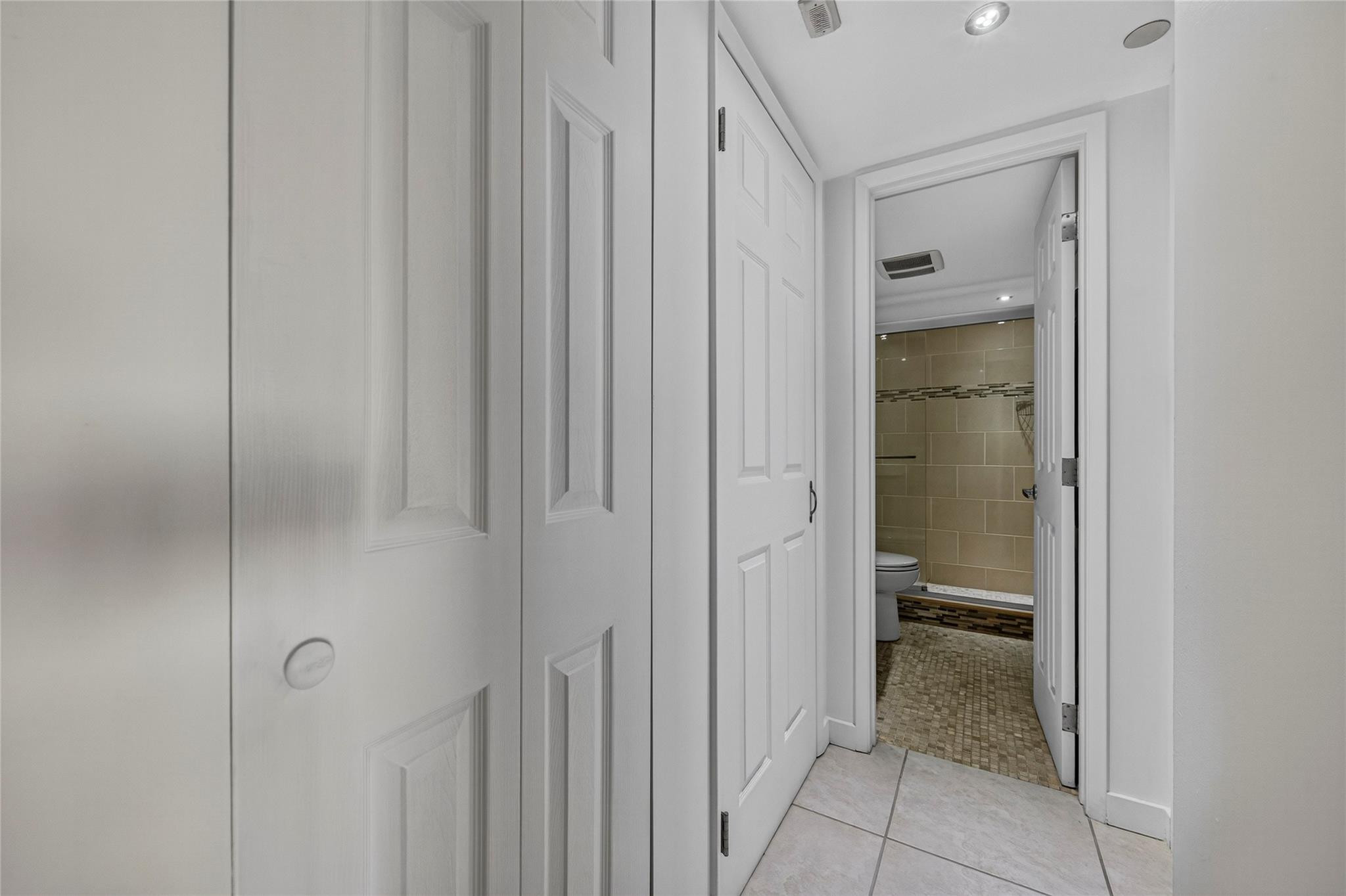 2900 North Course Drive, Unit 607 Pompano Beach, FL 33069 - Photo 40 of 48 a view of a bathroom from a hallway