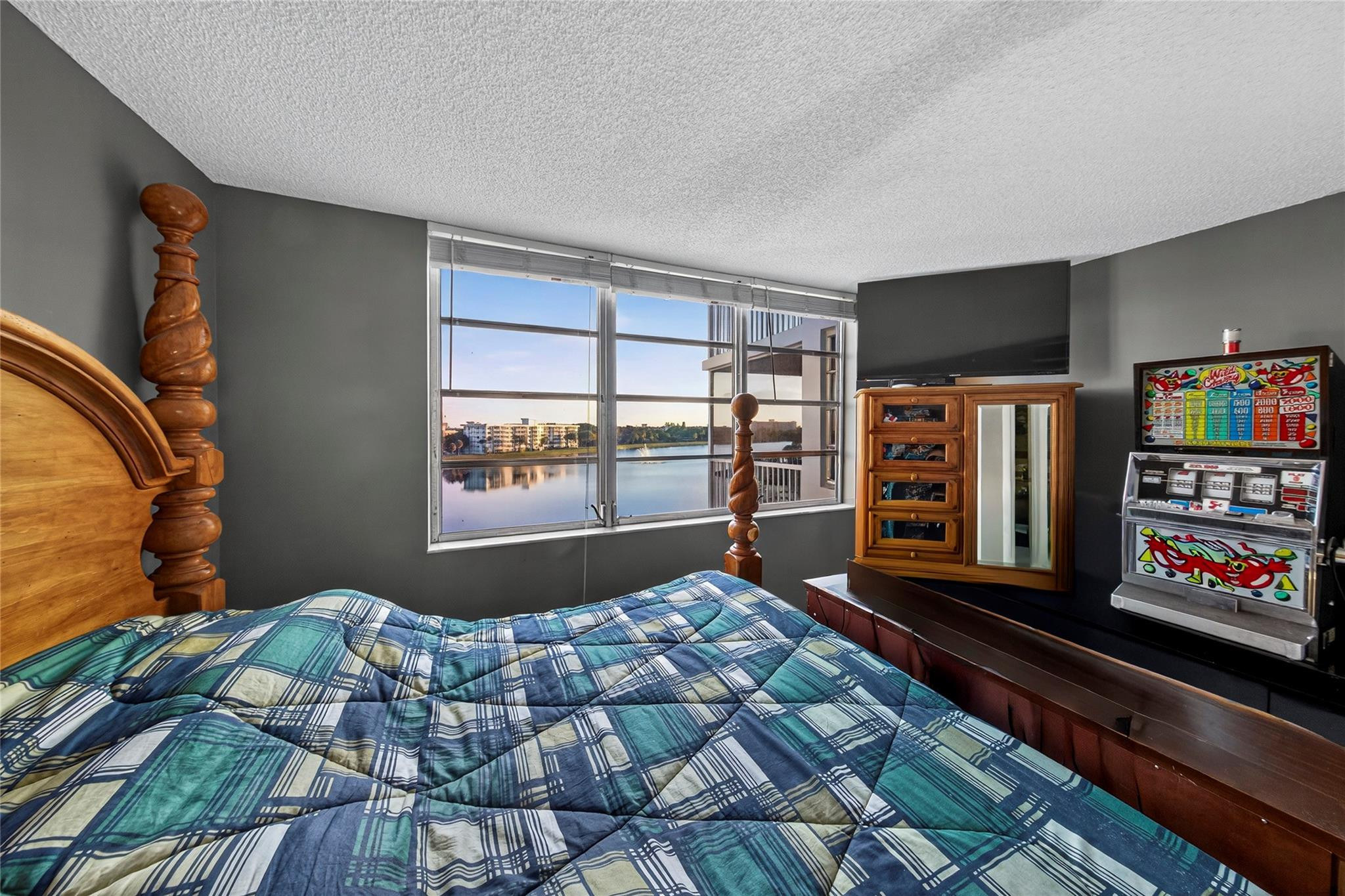 2900 North Course Drive, Unit 607 Pompano Beach, FL 33069 - Photo 43 of 48 a bedroom with a bed closet and flat tv screen