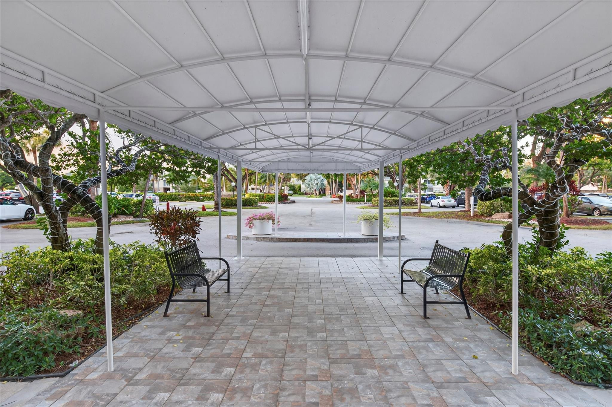 2900 North Course Drive, Unit 607 Pompano Beach, FL 33069 - Photo 46 of 48 a view of a chairs and table in backyard