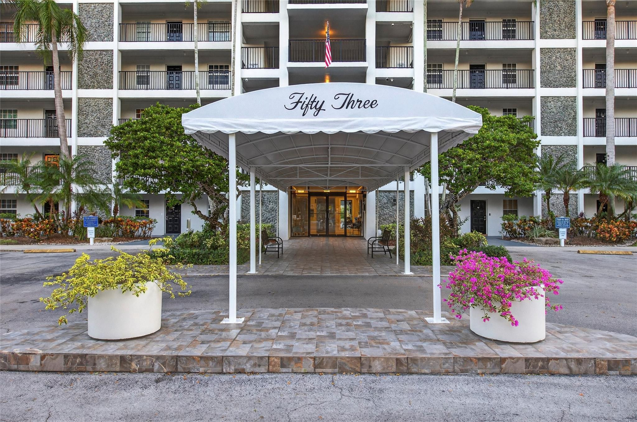 2900 North Course Drive, Unit 607 Pompano Beach, FL 33069 - Photo 47 of 48 a front view of a building with garden