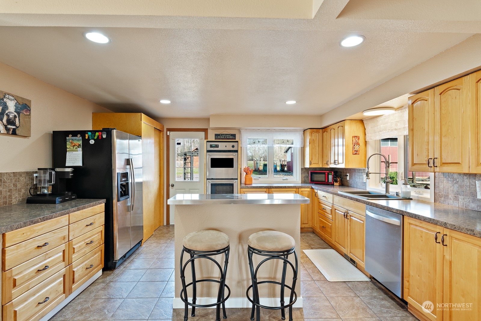 2820 Douglas Road Ferndale, WA 98248 - Photo 10 of 40 a large kitchen with kitchen island granite countertop lots of counter space and stainless steel appliances