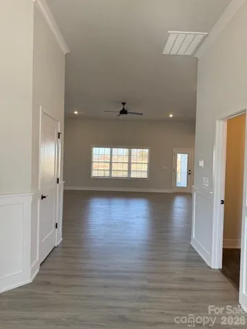 a kitchen with granite countertop a stove a sink and a microwave