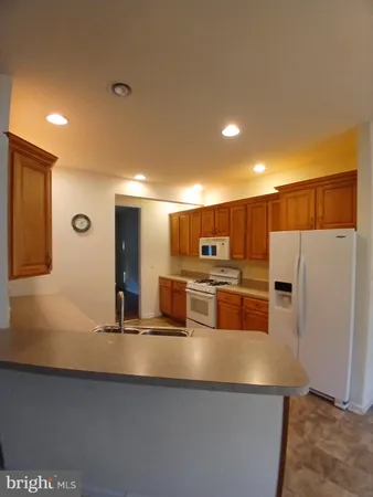 a large kitchen with stainless steel appliances a large counter top