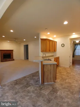 a view of kitchen with kitchen island microwave and stove
