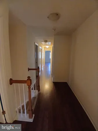 an empty room with wooden floor and door