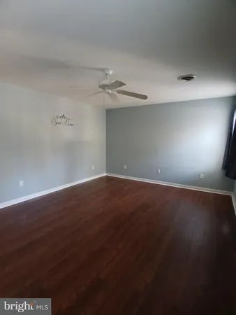 a view of wooden floor and windows in a room
