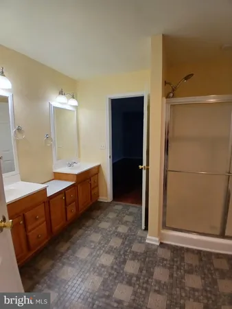 a bathroom with a double vanity sink and mirror