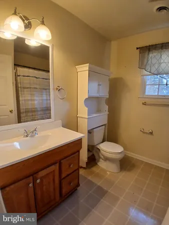 a bathroom with a shower toilet and sink