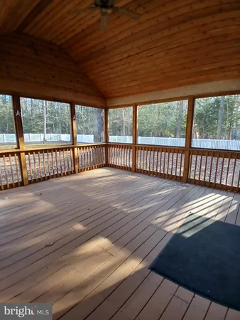 a view of a street with wooden fence