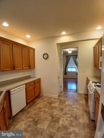 a kitchen with granite countertop a sink and a stove top oven