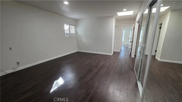 a bathroom with a sink a toilet a mirror and shower