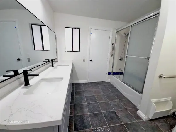 a bathroom with a glass door shower
